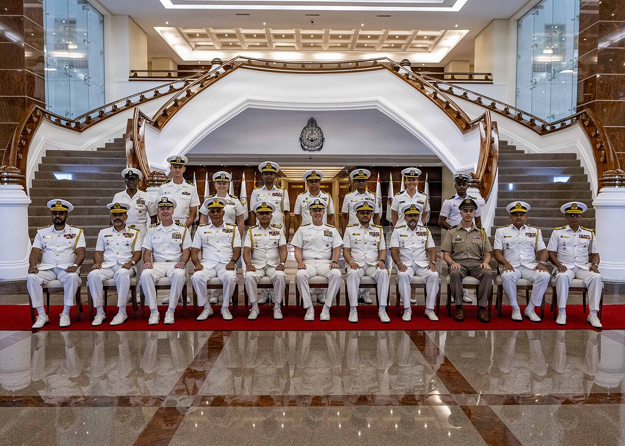Adm. Steve Koehler, commander, U.S. Pacific Fleet, center, and Vice Adm. Kanchana Banagoda, commander of the Sri Lanka Navy, center left, pose for a photo with their staffs during 