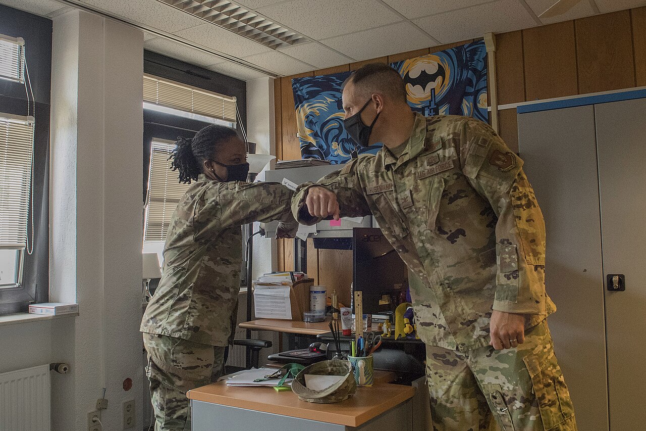 U.S. Air Force Col. Matt S. Husemann, 86th Airlift Wing vice commander, right, recognizes Tech. Sgt. Johne Tribble, 86th AW Judge Advocate adverse actions noncommissioned officer i