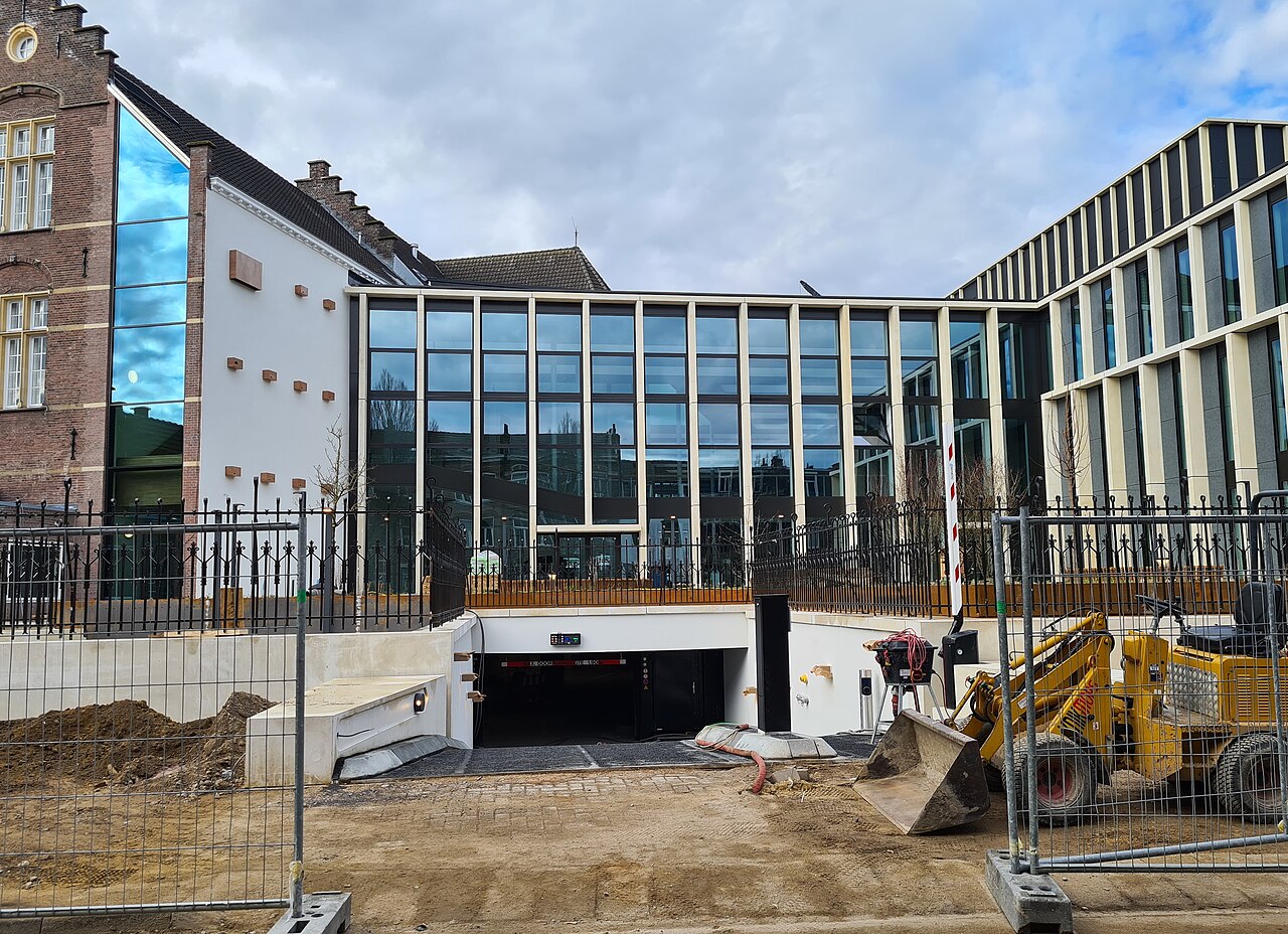 Bouw van het hoofdkantoor van dsm-firmenich in Maastricht, hier gezien vanaf de Turennestraat. De parkeergarage is het enige restant van de Euroscoop Cinema die hier voorheen stond