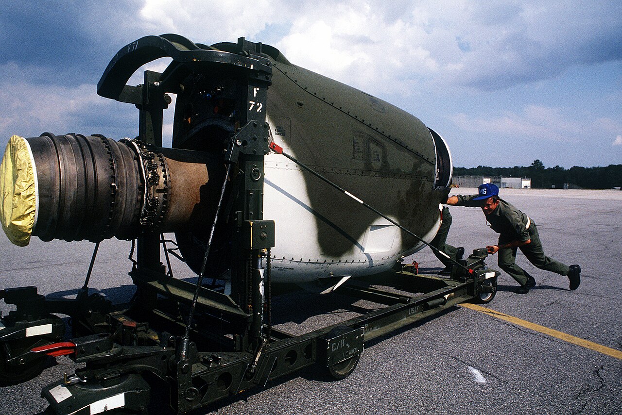 U.S. Air Force technicians from the 314th Field Maintenance Squadron move a replacement Allison T56 engine into place to be mounted in a Lockheed C-130 Hercules aircraft on 26 Sept