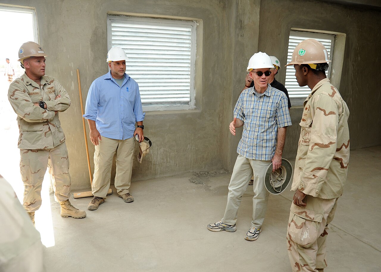 KONTALI, Djibouti (Jan. 4, 2011) U.S. Ambassador to the Republic of Djibouti James C. Swan and Builder 2nd Class Jermaine Blake, project crew leader assigned to Naval Mobile Constr